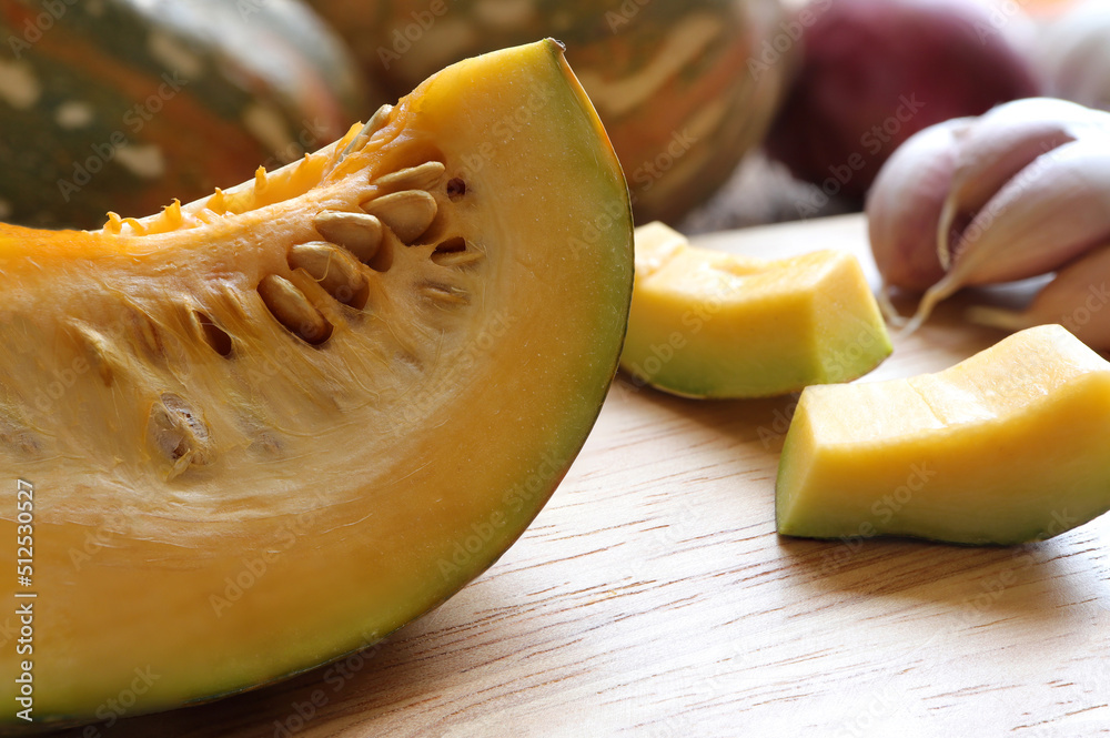 Close up of Butternut squash, pumpkin squash with spices for cooking on wooden cutting board. cooking concept, healthy food. Close up of Butternut squash, pumpkin squash with spices for cooking on wooden cutting board. cooking concept, healthy food.