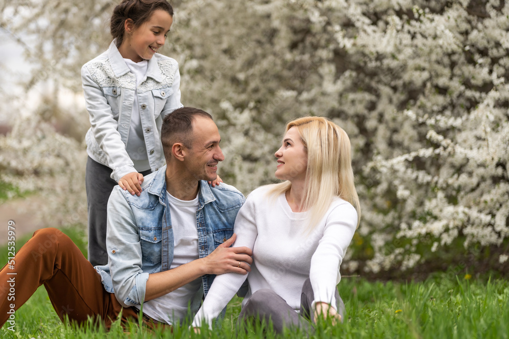 Happy male and female playing with child outside, spring. Happy male and female playing with child outside, spring.