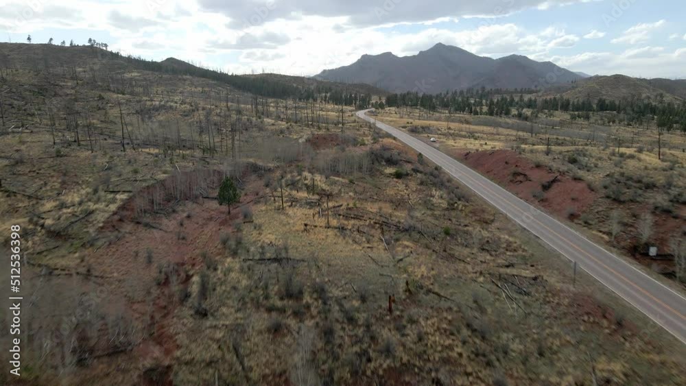 Drone tracking forward through trees and along a remote mountain road in the Pike National Forest, Rocky Mountains, Colorado. Drone tracking forward through trees and along a remote mountain road in the Pike National Forest, Rocky Mountains, Colorado.