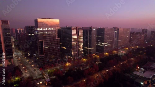 Aerial orbit of business buildings at sunset near Parque Araucano, Santiago, Chile photo