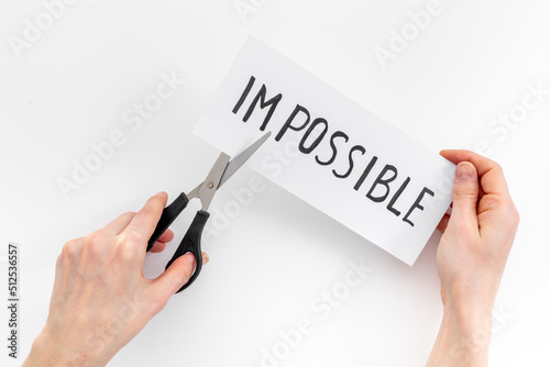 Plakat Hands changing word impossible to possible with scissors. Selfmade concept