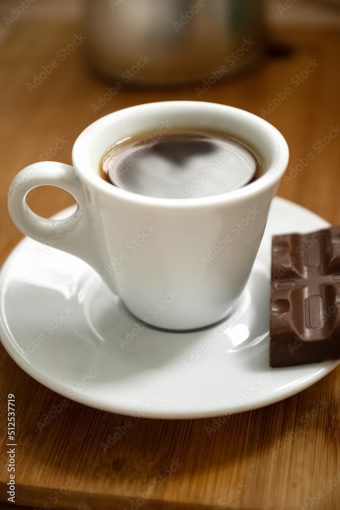 Close up cup of espresso coffee with piece of chocolate on plate Close up cup of espresso coffee with piece of chocolate on plate