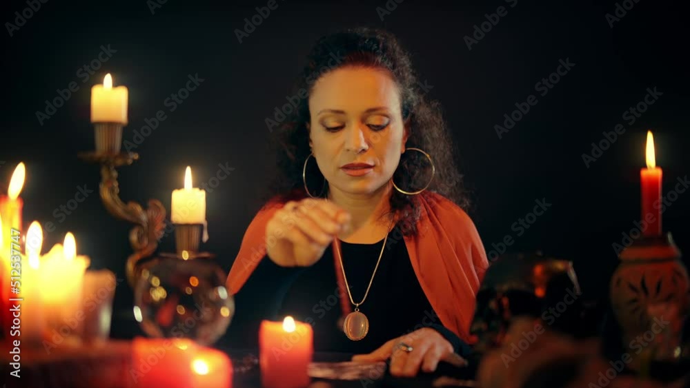 Female occultist making a spell, catching damage over photo, enchantment, magic Female occultist making a spell, catching damage over photo, enchantment, magic