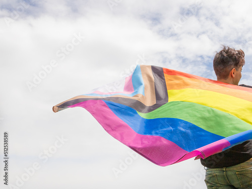 Pride month. Young lesbian girl waving the lgbtiq  flag on the pride day. Celebrating the lgbt lesbian women rights.