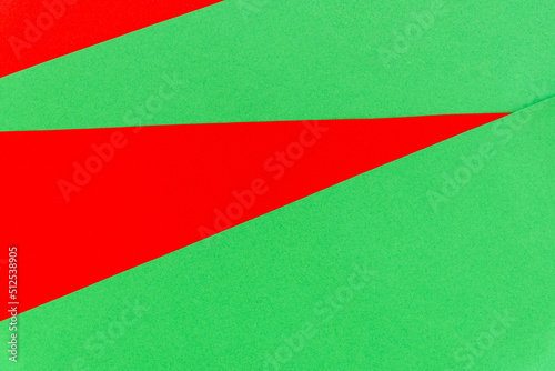 Abstract bright red on green paper background.