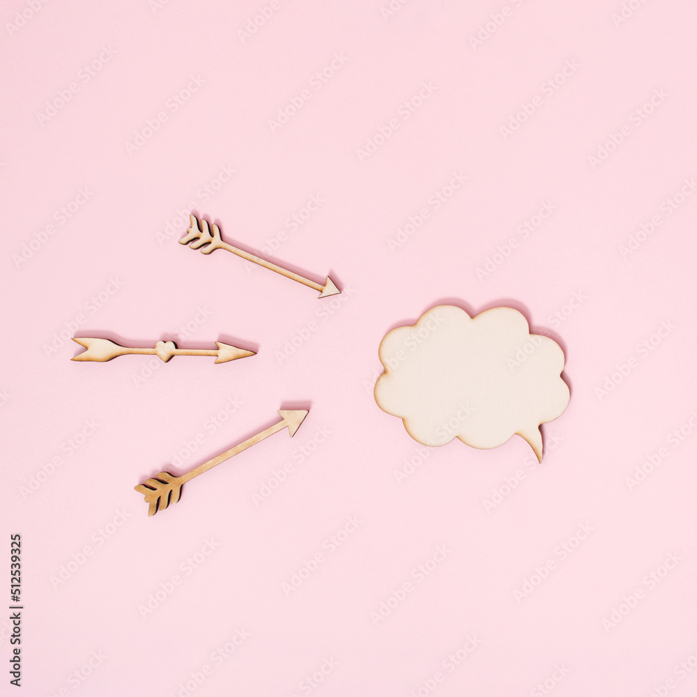 Arrows targeting conversation box on pastel pink background. Minimal concept of attacked discussion or public speaking idea. Arrows targeting conversation box on pastel pink background. Minimal concept of attacked discussion or public speaking idea.