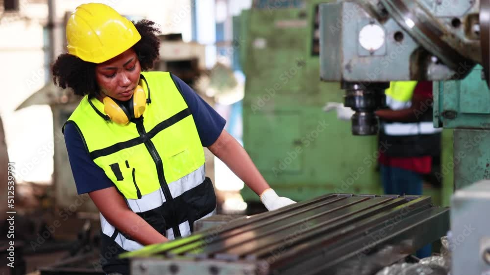 Woman worker wearing safety goggles control lathe machine to drill components. Metal lathe industrial manufacturing factory Woman worker wearing safety goggles control lathe machine to drill components. Metal lathe industrial manufacturing factory