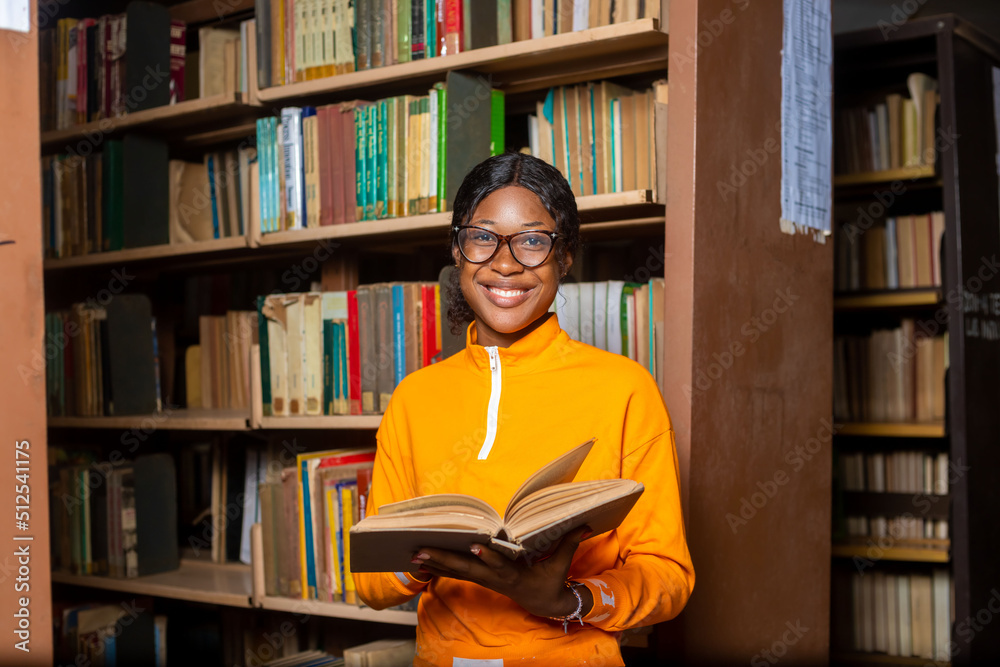 young lady campus student in the library reading. young lady campus student in the library reading.
