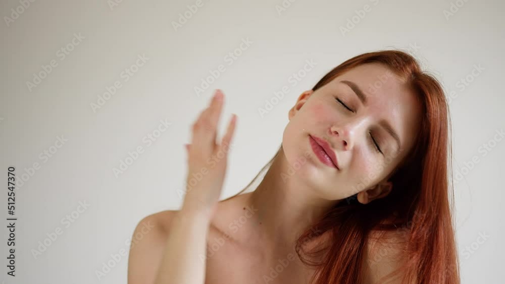 Beautiful red-haired young woman gently strokes her neck and flirting Beautiful red-haired young woman gently strokes her neck and flirting