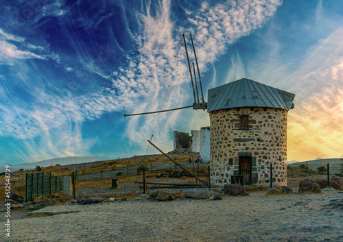 Symbol of the city of Bodrum Turkey ancient windmill on a hill. Sky with clouds. photo