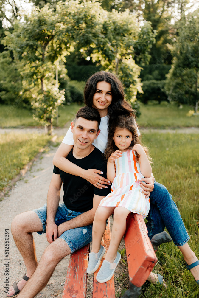 Happy family mom dad and daughter outdoors Happy family mom dad and daughter outdoors