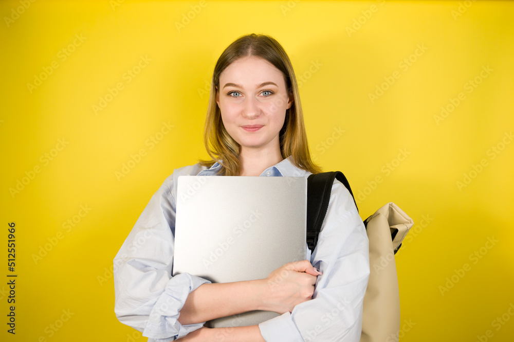 Smart looking girl student on yellow background.Back to school concept Smart looking girl student on yellow background.Back to school concept