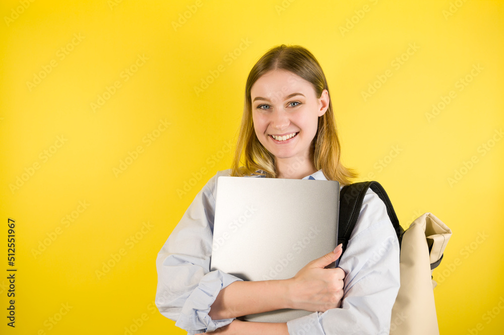 Happy smiling female student studio portrait on yellow background. Happy smiling female student studio portrait on yellow background.