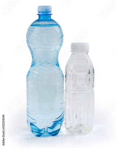 Two different plastic bottles of drinking water on white background