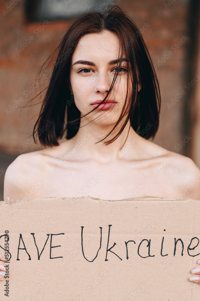 Close up Portrait of Nude Woman with Poster Save Ukraine. woman with a
