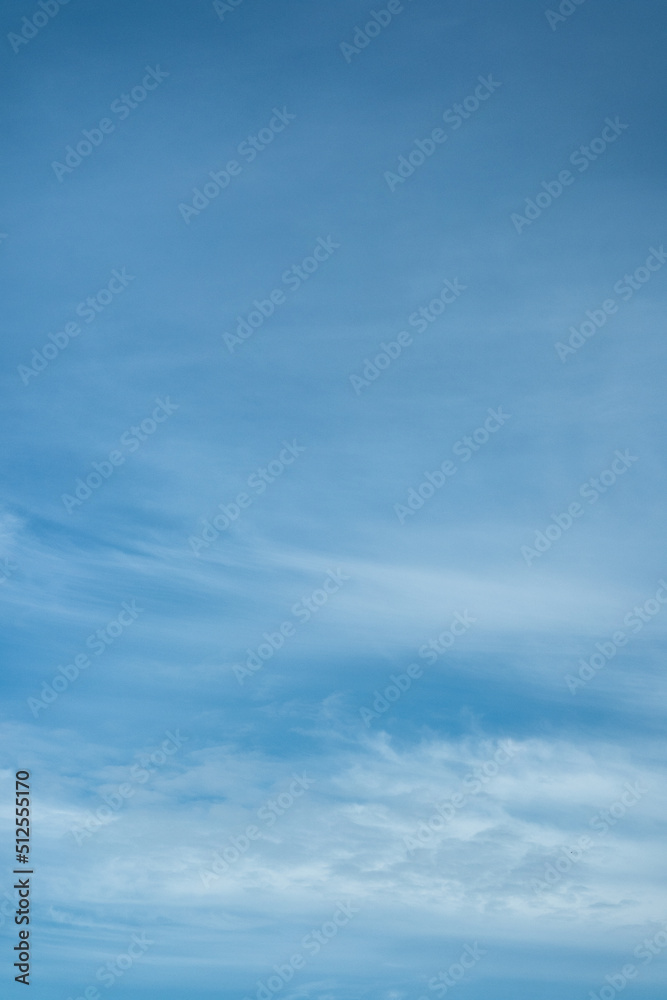 Light cloudy blue sky vertical background.