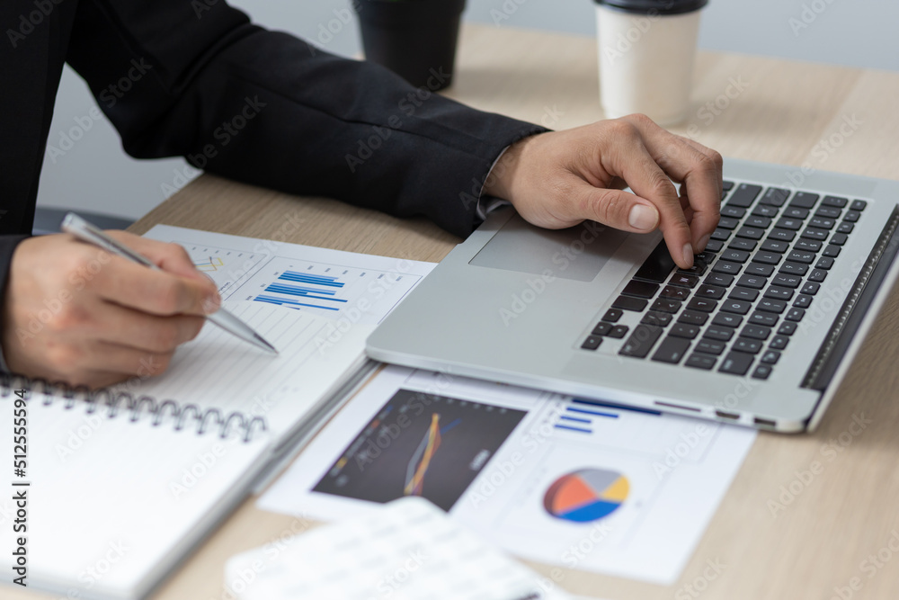 Businessman or accountant analysis financial report, computer with graph chart. Finance and Accounting concepts. Businessman or accountant analysis financial report, computer with graph chart. Finance and Accounting concepts.