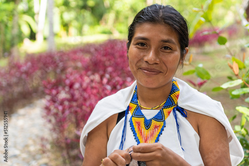 Stock photo of a portrait of a Colombian woman in traditional clothing. Beautiful shot of a young indigenous woman from the Sierra Nevada de Santa Marta, smiling looking at the camera. photo