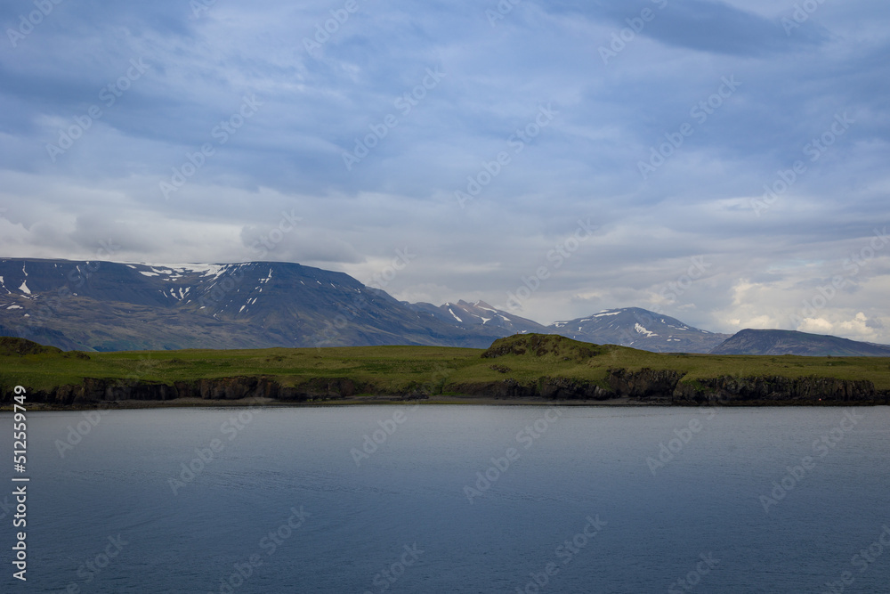 Icelandic Atlantic coastline with pattern of moss covered hills and majestic mountains
