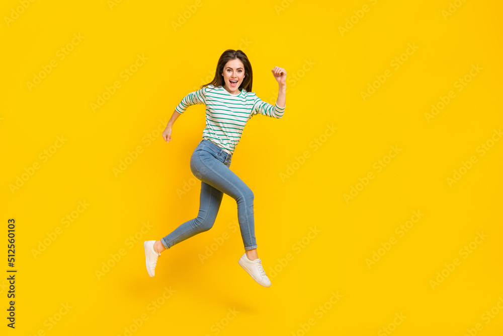 Full length profile side photo of cheerful energetic good mood female running traveling isolated on yellow color background Full length profile side photo of cheerful energetic good mood female running traveling isolated on yellow color background
