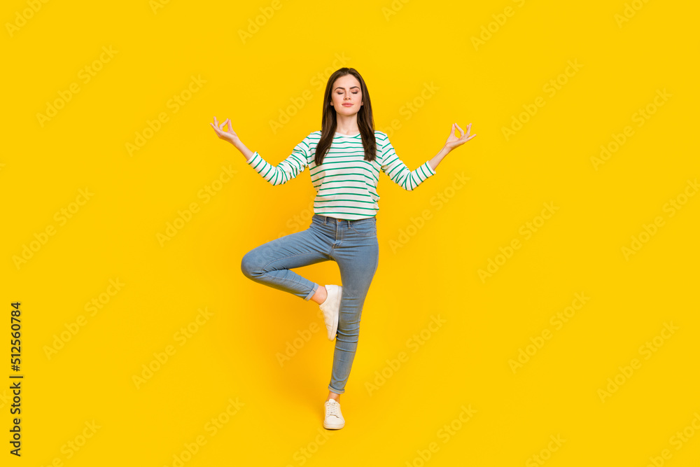 Full body image of beautiful charming woman practice mindfulness doing yoga isolated on yellow color background