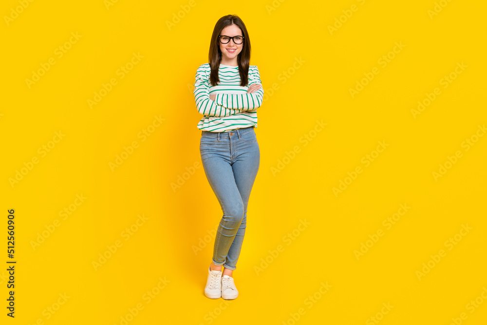 Full body image of young stunning gorgeous business lady with folded arms isolated on yellow color background Full body image of young stunning gorgeous business lady with folded arms isolated on yellow color background
