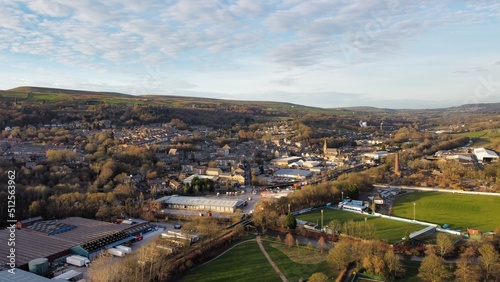 Aerial view looking down onto trees and countryside with houses and buildings in a rural setting. Taken in Lancashire England. 