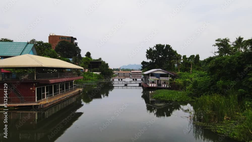 A pan shot of the floating house on river Kwai along with its surroundings in Kanchanaburi, Thailand. A pan shot of the floating house on river Kwai along with its surroundings in Kanchanaburi, Thailand.