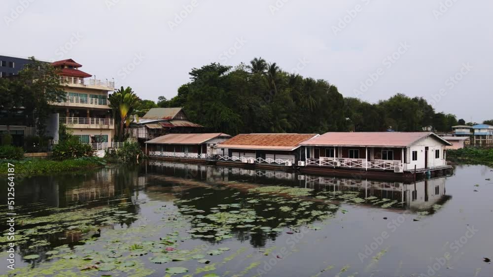 An amazing view of many wooden house floating on the river with mountain in Kanchanaburi, Thailand An amazing view of many wooden house floating on the river with mountain in Kanchanaburi, Thailand