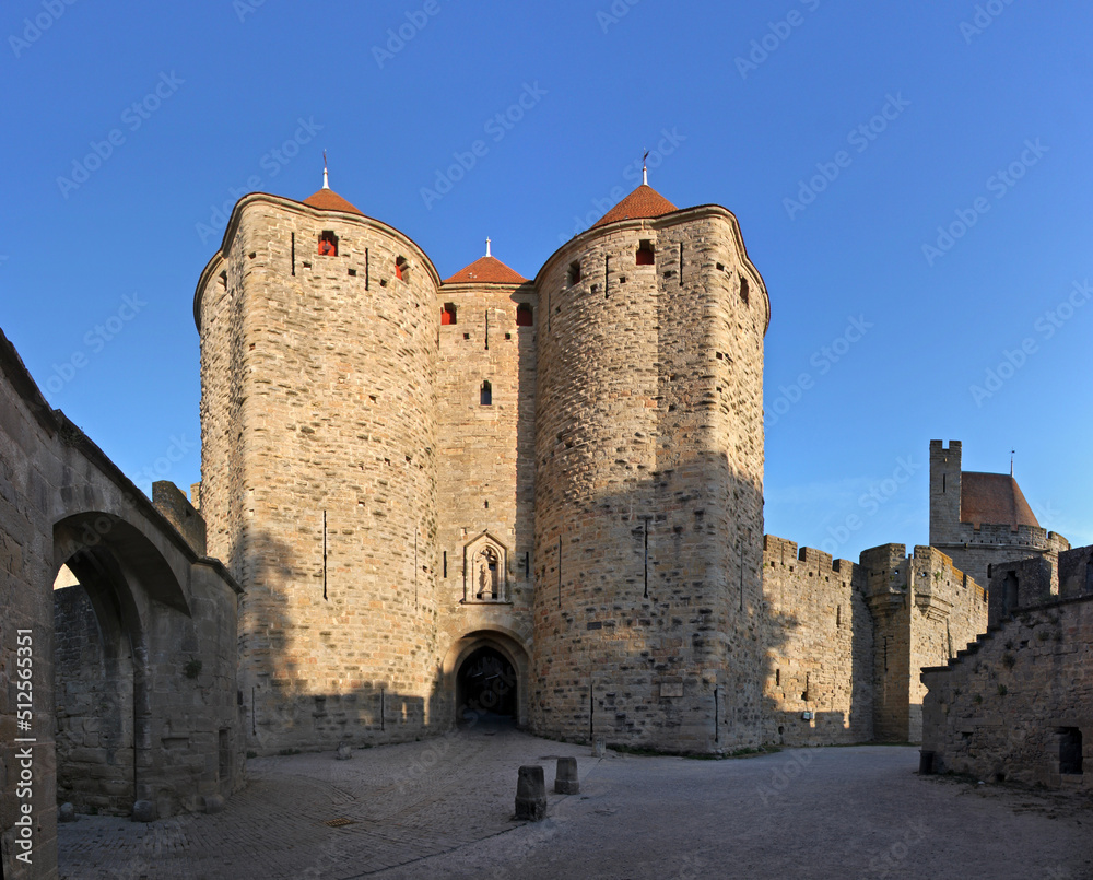 Porte Narbonnaise city gate at the rampart wall of Carcassonne with its moat, towers and Aude department in France