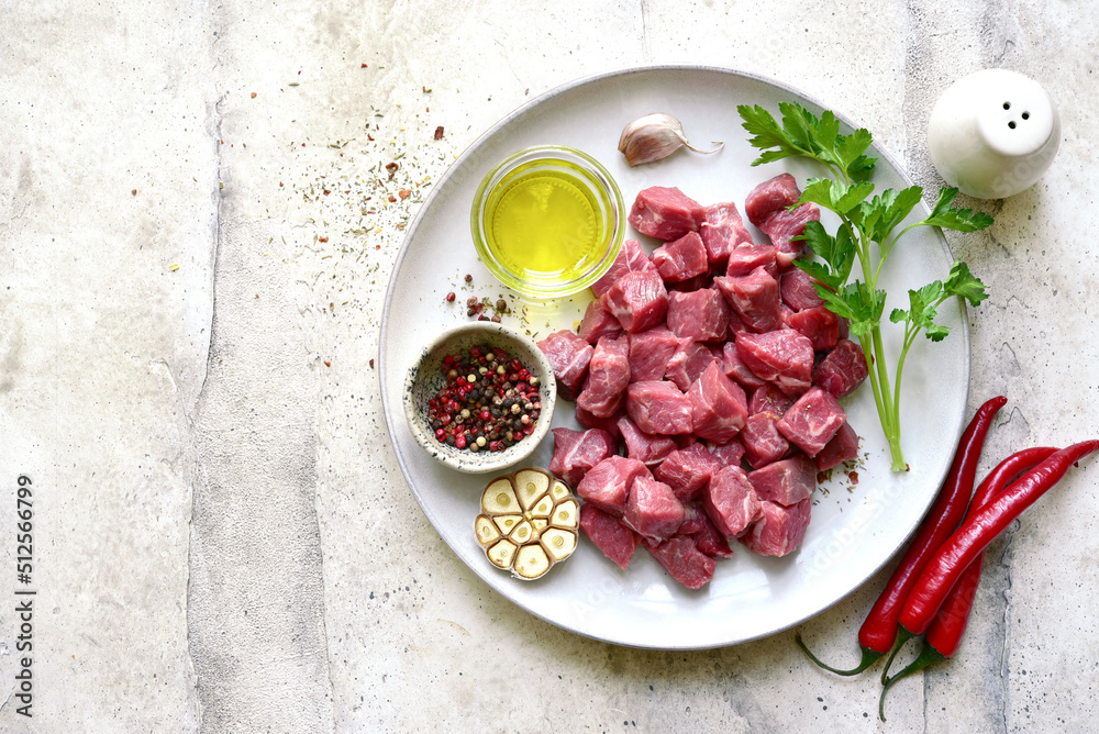 Raw meat cubes with spices. Top view with copy space. Raw meat cubes with spices. Top view with copy space.