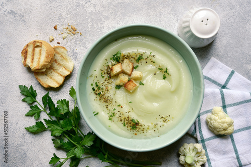 Vegetarian cauliflower cream soup with croutons. Top view with copy space.