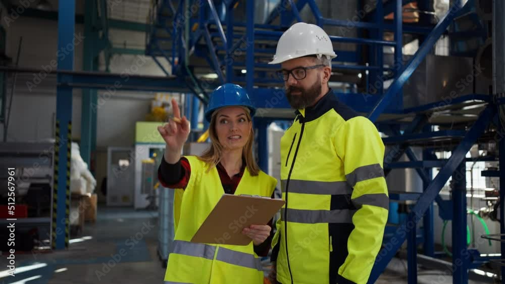 Engineering manager and mechanic worker doing routine check up in industrial factory Engineering manager and mechanic worker doing routine check up in industrial factory