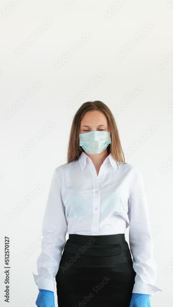 Pandemic prevention. Office hygiene. Covid-19 protective measures. Vertical portrait of business woman in face mask gloves spraying hands with antiseptic isolated on white copy space set of 2. Pandemic prevention. Office hygiene. Covid-19 protective measures. Vertical portrait of business woman in face mask gloves spraying hands with antiseptic isolated on white copy space set of 2.