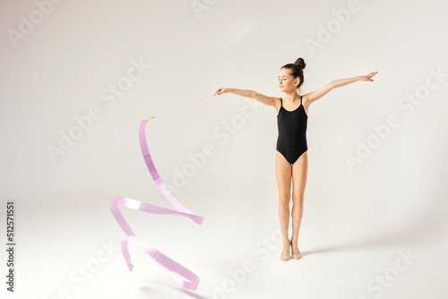 Girl gymnast performs a jump to the top.