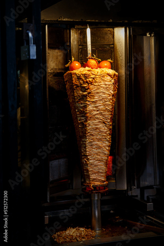 Traditional Turkish food Doner Kebab. Chicken meat grilled on the street.