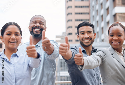 Always be proud of what you do. Shot of a group of businesspeople giving the thumbs up.
