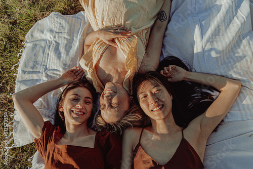 HAPPY GIRLS STUDYING TOGETHER IN THE COUNTRYSIDE.  photo