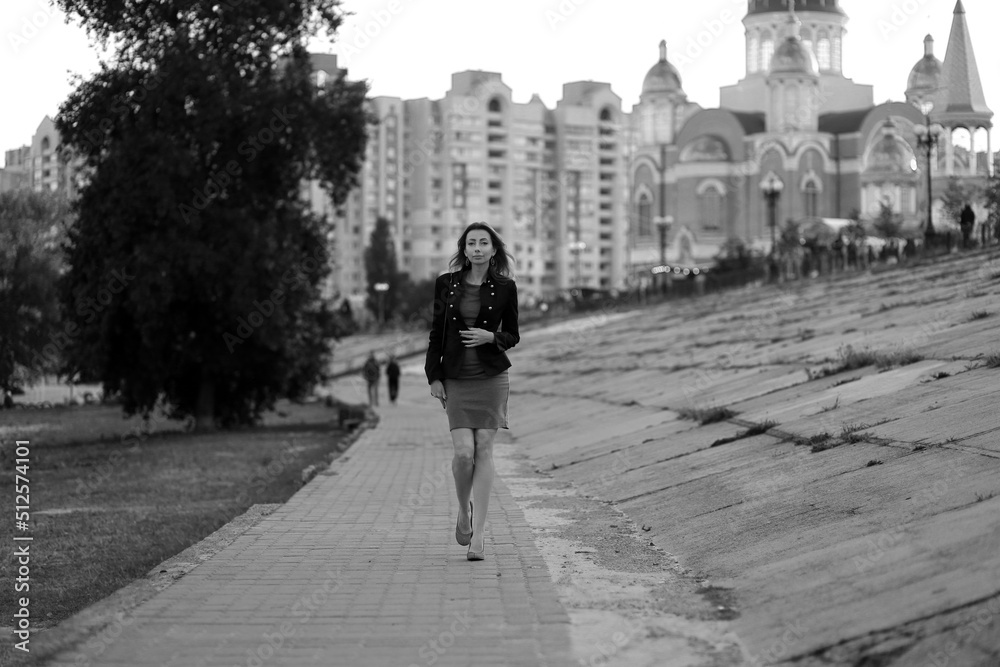 Beautiful woman walking in the street in black and white
