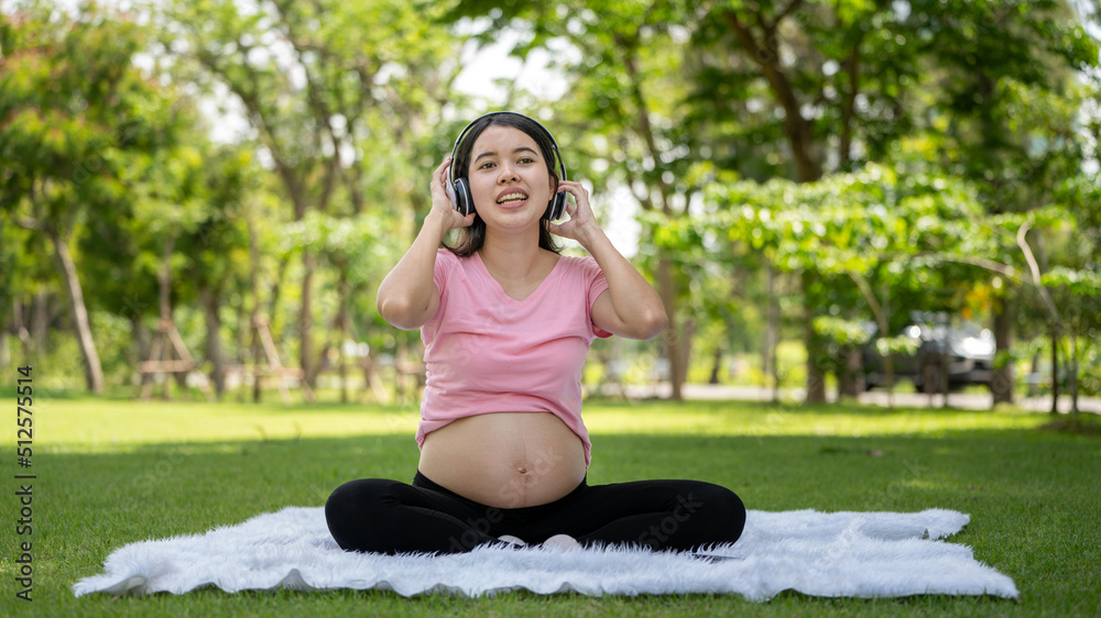 Pregnant woman touching belly in the City Park, Pregnant Relaxing and exercise, Beautiful tender mood photo of pregnancy Pregnant woman touching belly in the City Park, Pregnant Relaxing and exercise, Beautiful tender mood photo of pregnancy