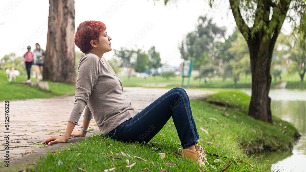 latin woman breathing air taking a moment from work in the park bogota colombia latin woman breathing air taking a moment from work in the park bogota colombia