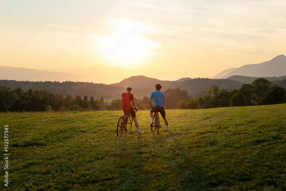 Cyclist on a racing bike outdoors in nature at sunset. Cyclist on a racing bike outdoors in nature at sunset.