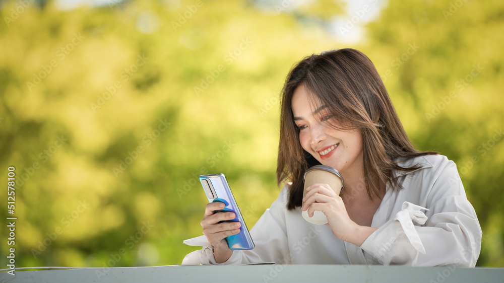 Young stylish woman drinking coffee and using paper cup and to go in a park, young people female hand holding paper cup of take away drinking coffee on natural morning
Young stylish woman drinking coffee and using paper cup and to go in a park, young people female hand holding paper cup of take away drinking coffee on natural morning