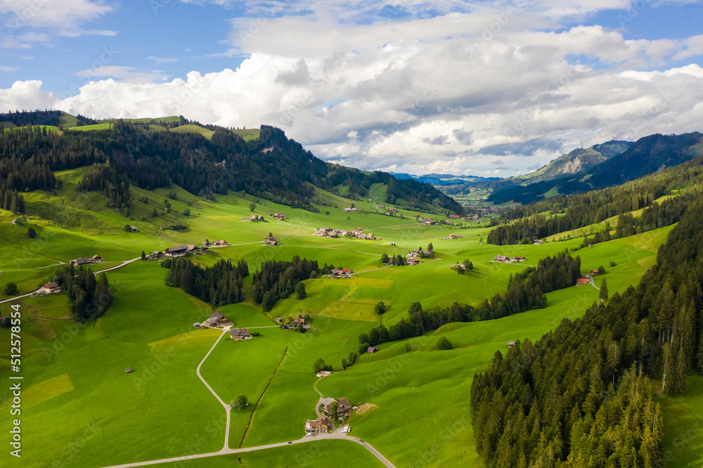 Aerial view of fields and landscape with mountains in the center of Switzerland in the Berner Oberland