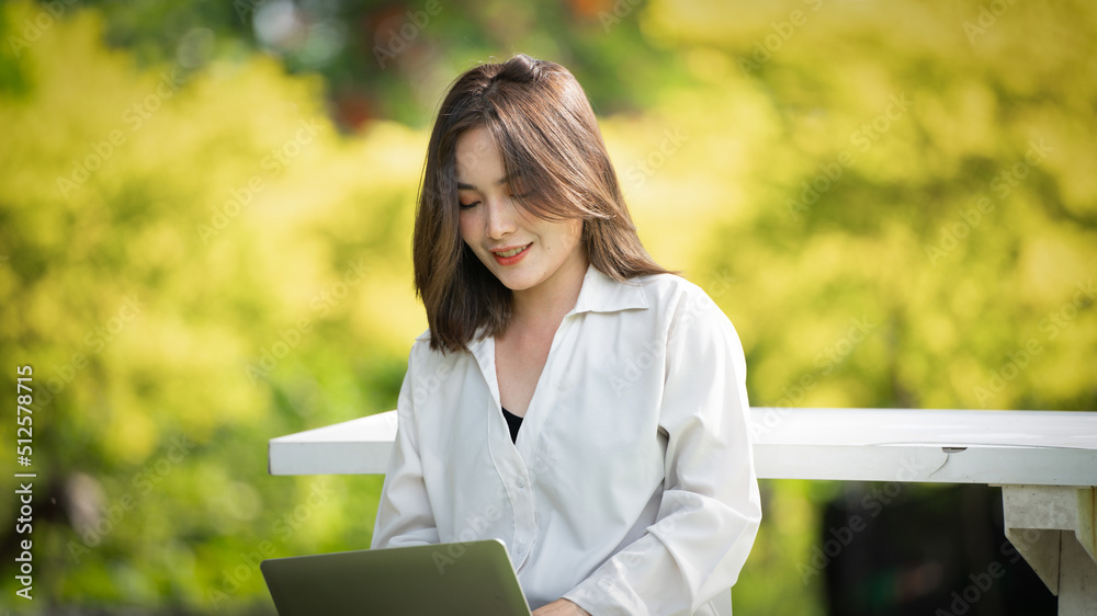 Thoughtful smile woman in park using smart digital tablet, Portrait of a young charming business woman checking online Business work on her smart tablet or labtop outdoors in the park on soft screen Thoughtful smile woman in park using smart digital tablet, Portrait of a young charming business woman checking online Business work on her smart tablet or labtop outdoors in the park on soft screen