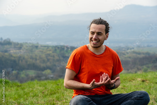 Man sitting on the mountain and telling something © Anton Tolmachov