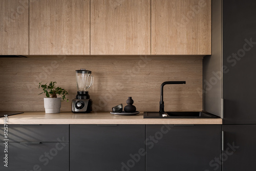 Wooden kitchen countertop with black sink photo