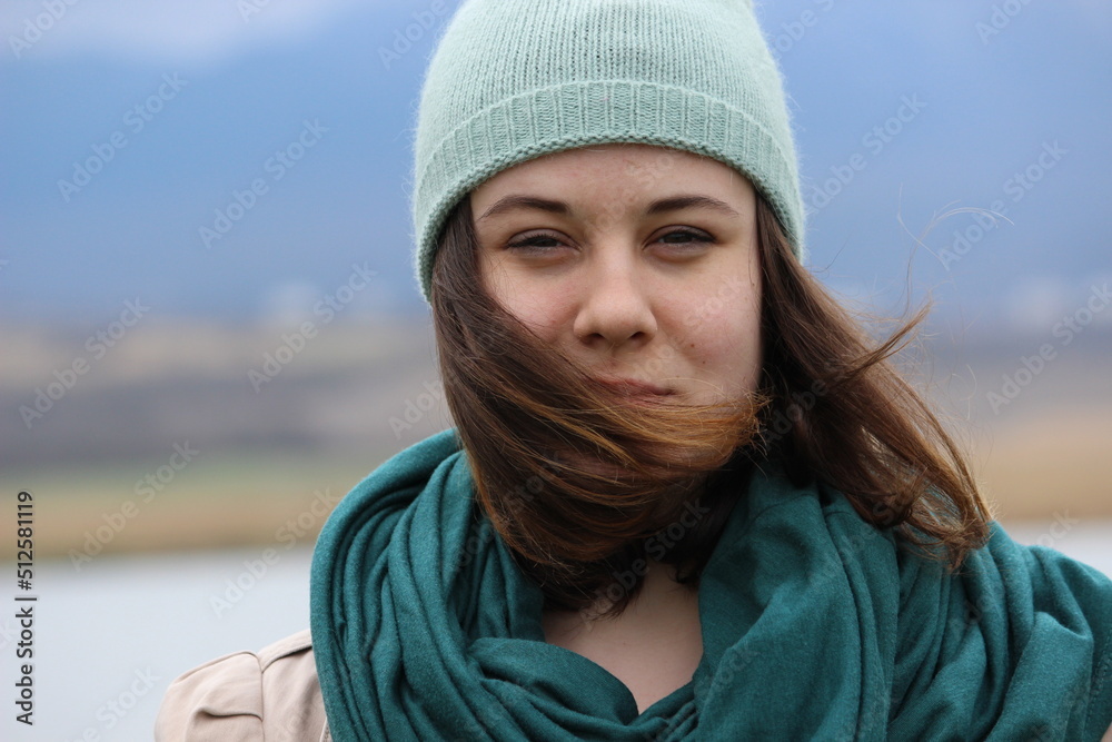 Portrait of a girl of European appearance with long hair on the street. Portrait of a girl of European appearance with long hair on the street.
