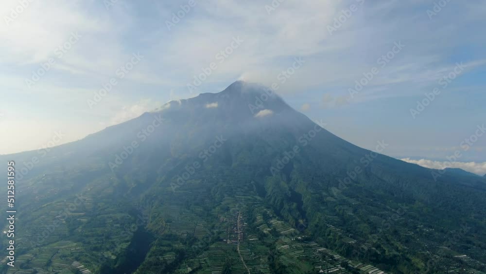 Majestic volcano Mount Merapi peak over serene Wonolelo village, Indonesia, aerial view Majestic volcano Mount Merapi peak over serene Wonolelo village, Indonesia, aerial view