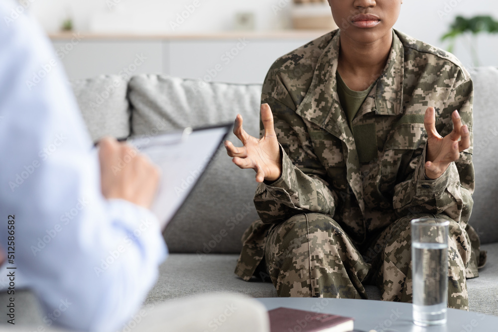 Stressed African American Military Woman Talking To Psychotherapist During Meeting In Office